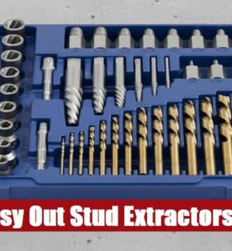 A metal toolbox containing an easy out stud extractor set lying flat on a rough gray cement surface.