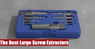 A professional large screw extractor set case resting on a rough cement floor for heavy mechanical work.