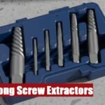 Open professional long screw extractor toolbox lying on a gray cement floor for tough fastener projects.