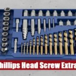 Professional phillips head screw extractor kit toolbox lying on a gray cement floor in a home workshop.