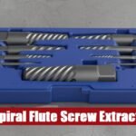 Heavy duty spiral flute screw extractor set inside an open case lying on a gray concrete floor surface.