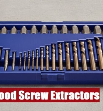 Open toolbox with a wood screw extractor set lying on a cement floor ready for professional repair work.