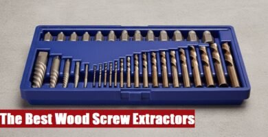 Open toolbox with a wood screw extractor set lying on a cement floor ready for professional repair work.